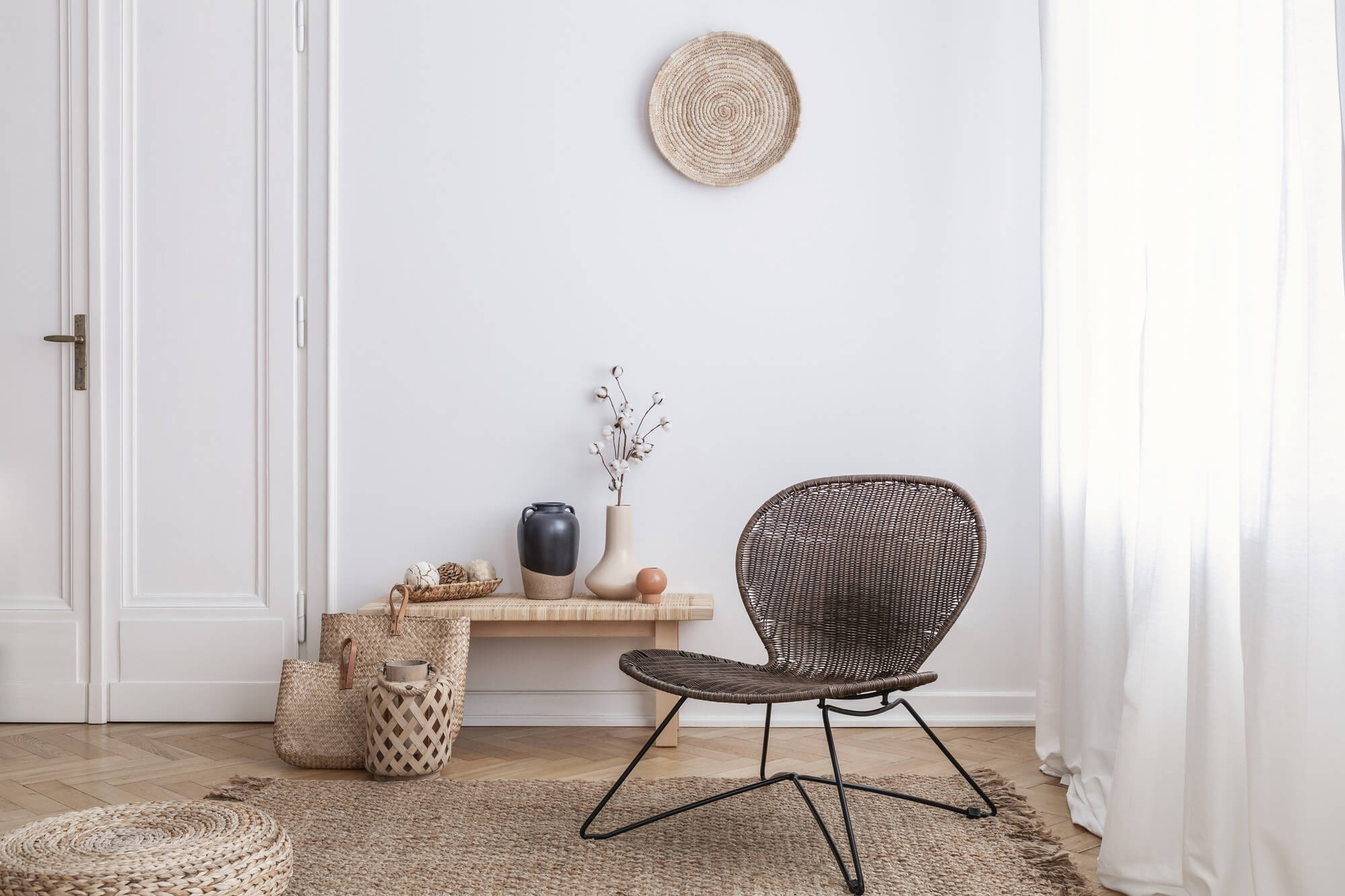 modern armchair and pouf on brown carpet in white apartment inte.jpg